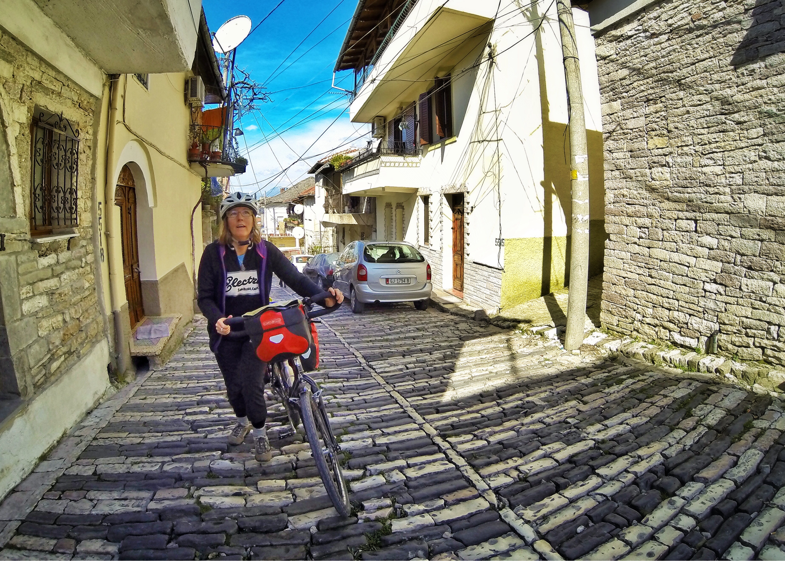 Bicycle Touring Albania. Pushing up the steep cobblestone streets of Gjirokaster