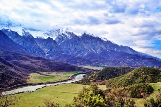 Bicycle Touring Albania. Lumi Vjosa River surrounded by mountains